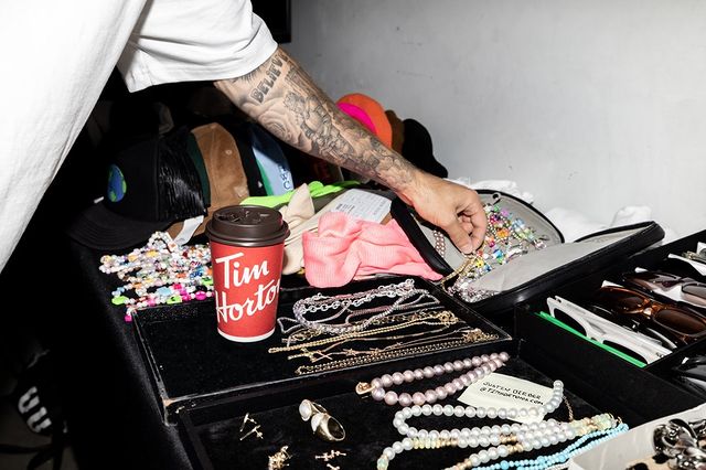 Believe Tattoo on Bieber's forearm seen while is trying to pick up jewelry from a bag